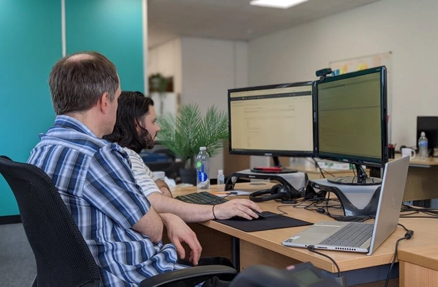 Colleagues at a desktop computer
